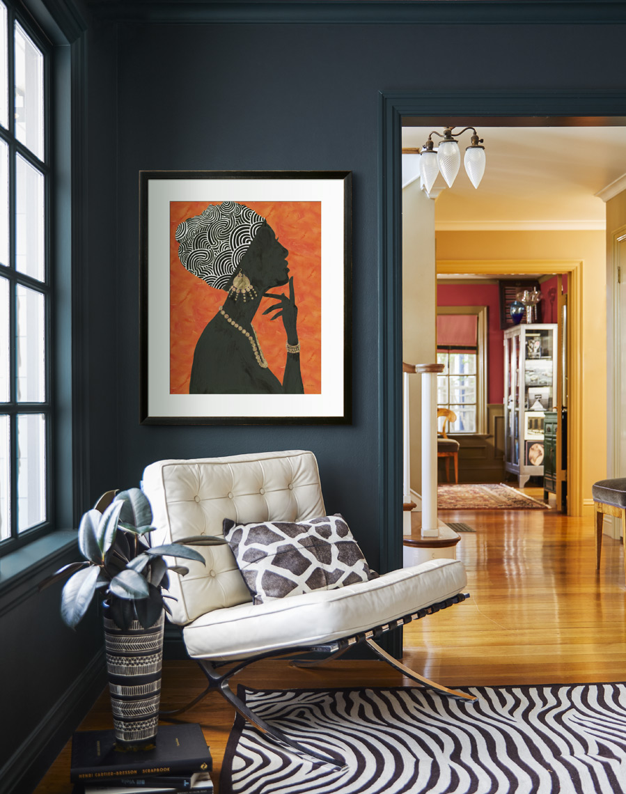 Barcelona Chair under framed print on dark wall with zebra rug 