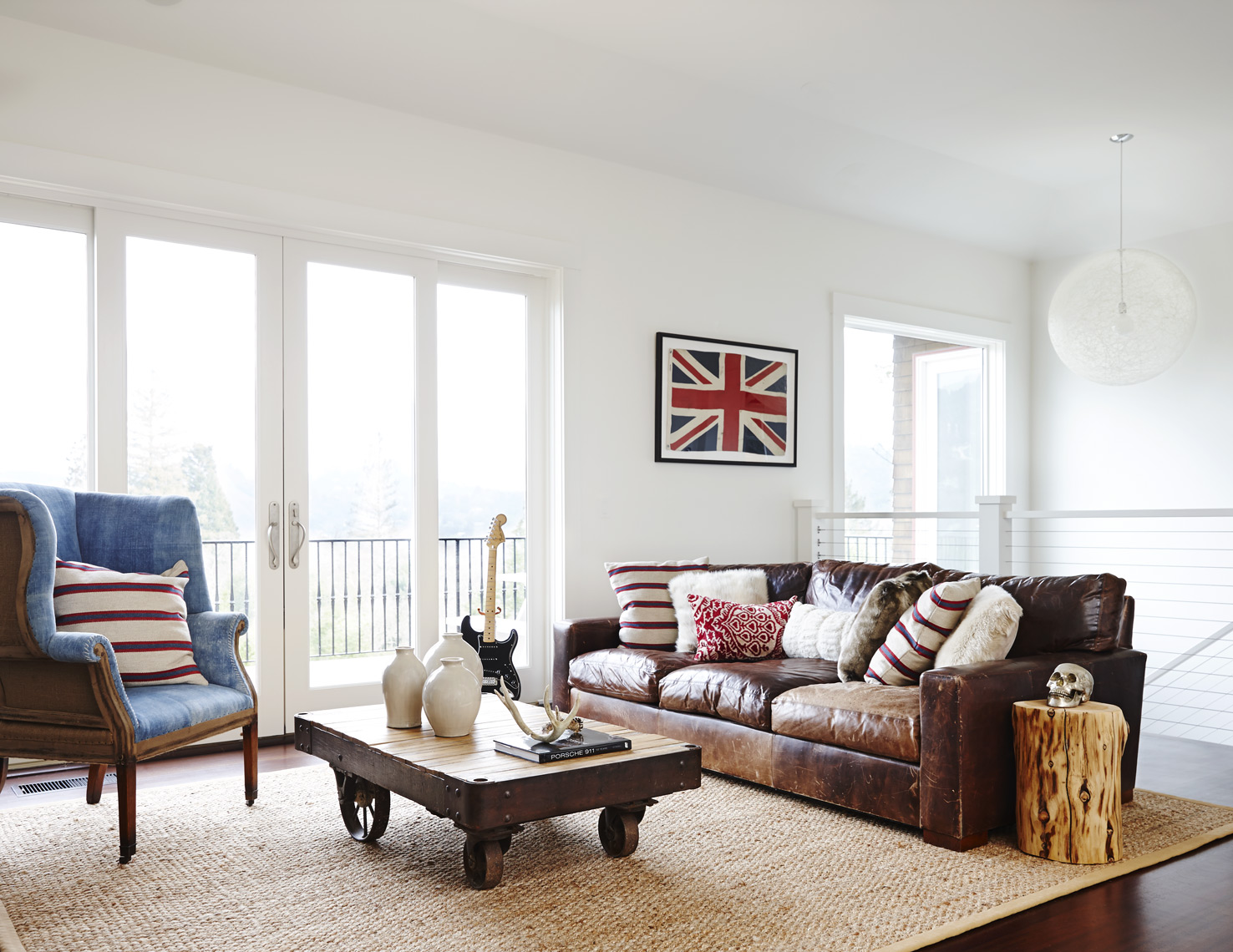 Living room in Marin designed by interior designer with leather couch side chair and sisal rug