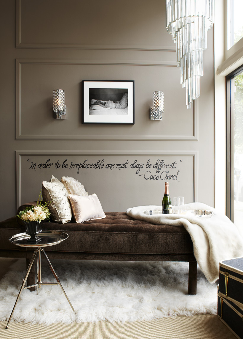 Interior design studio showroom with chaise lounge  rug and Coco Chanel quote on wall Sean Dagen Photography