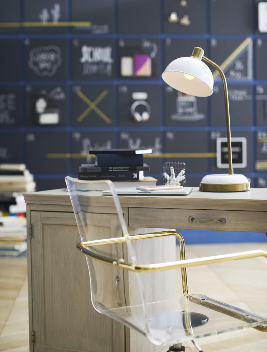 Desk in room with chalkboard wall and lucite chair Sean Dagen Photography