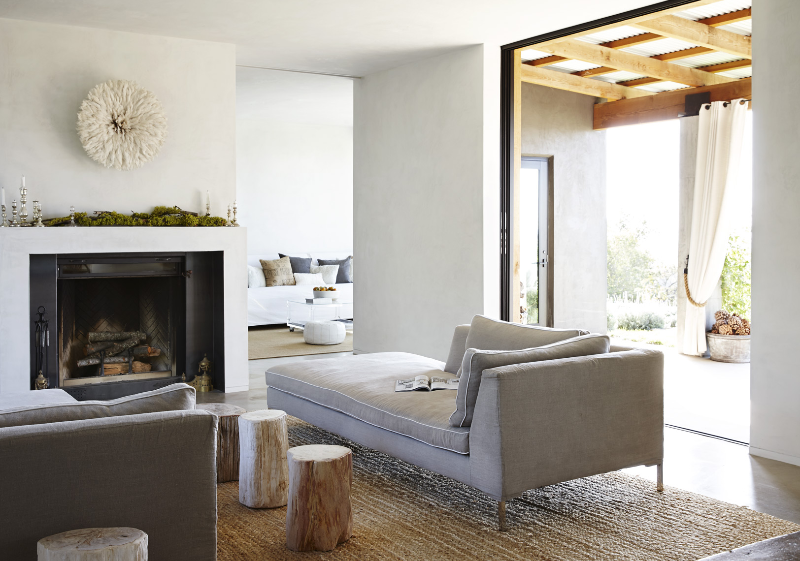 Modern living room with fireplace view outside chaise lounger petrified wood Sean Dagen Photography