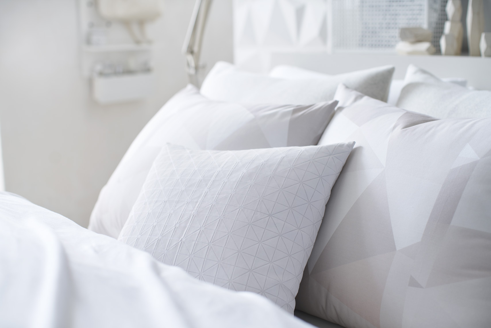 Bedding detail of geometric pattern decorative pillows