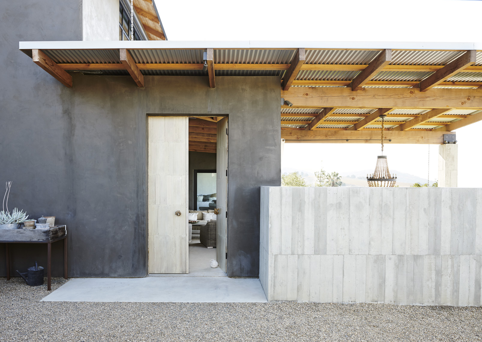 Exterior of modern design house in Napa Valley with cement walls french doors and hardscape Sean Dagen Photography