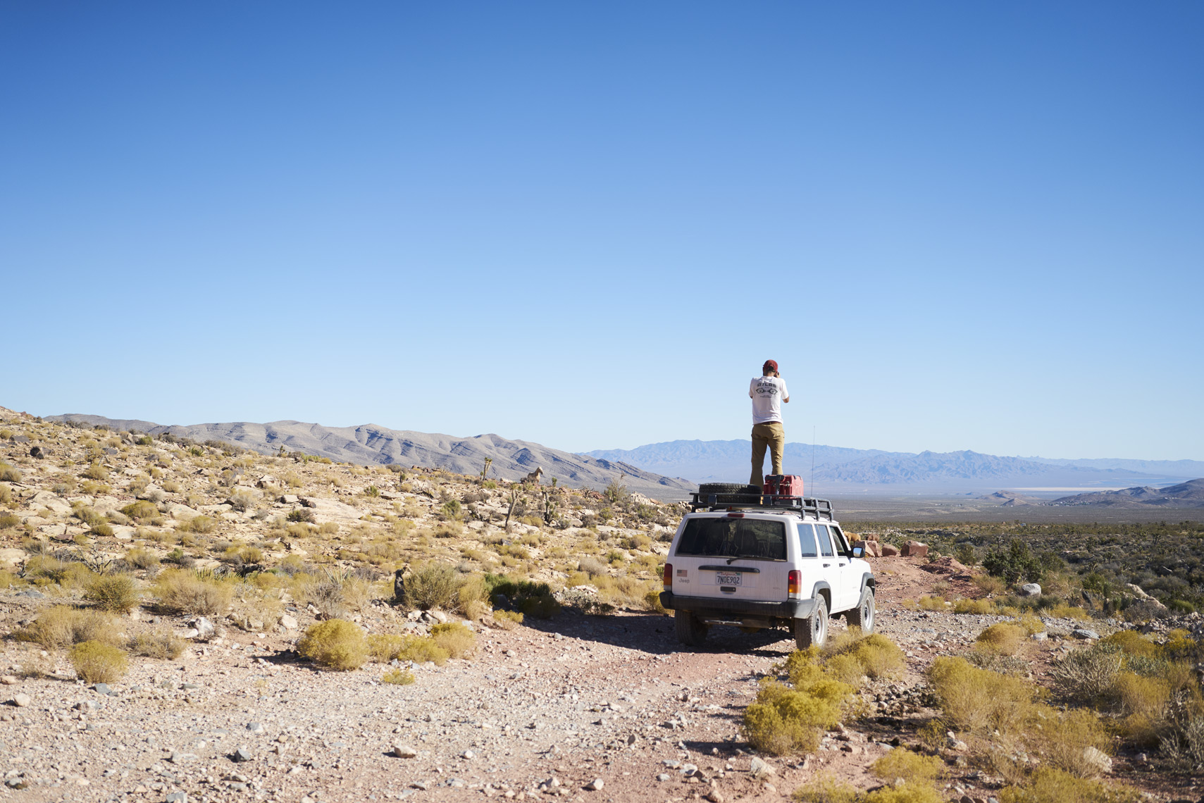 Taking in the view atop a Jeep Cherokee in Mojave National Preserve Sean Dagen Photography
