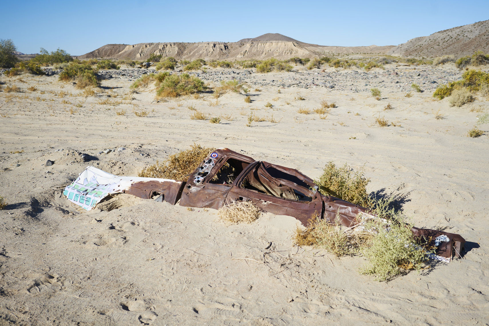 Pickup truck buried by sand in a wash near afton canyon in mojave national preserve Sean Dagen Photography